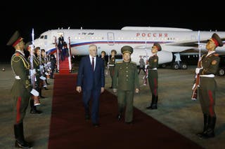 Russian interior minister Vladimir Kolokoltsev walks with North Korean public security minister Pang Tu Sop on his arrival at the Pyongyang International Airport in Pyongyang